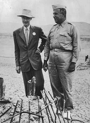 Nuclear physicist Julius Robert Oppenheimer (1904 - 1967), left, with Major General Leslie Groves, by the remains of the tower from which an atom test bomb was ignited, at Los Alamos, California